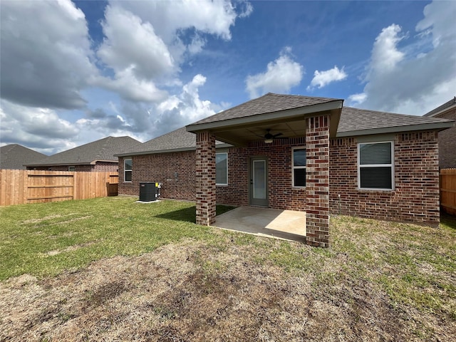 back of property featuring ceiling fan, central AC, a lawn, and a patio area