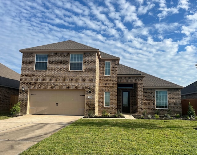 view of front of property featuring a front lawn and a garage