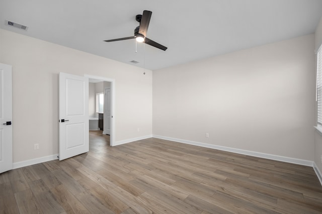 empty room with ceiling fan and light wood-type flooring