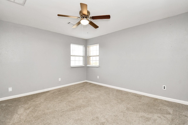 carpeted empty room featuring ceiling fan