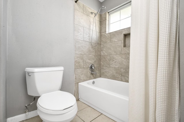 bathroom with toilet, shower / bath combo, and tile patterned floors