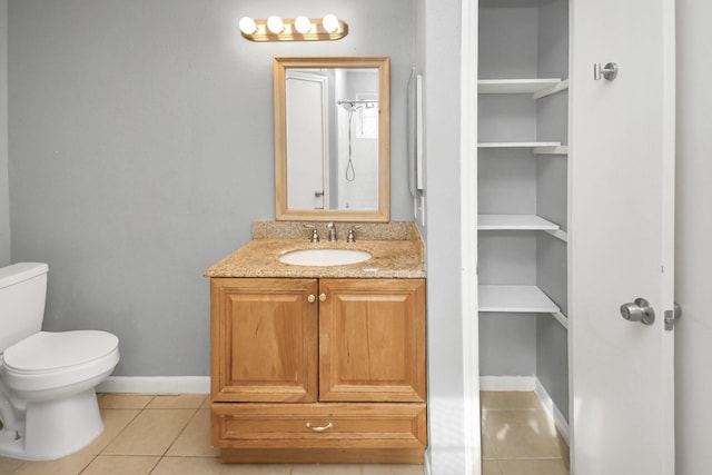 bathroom with toilet, tile patterned floors, walk in shower, vanity, and built in shelves