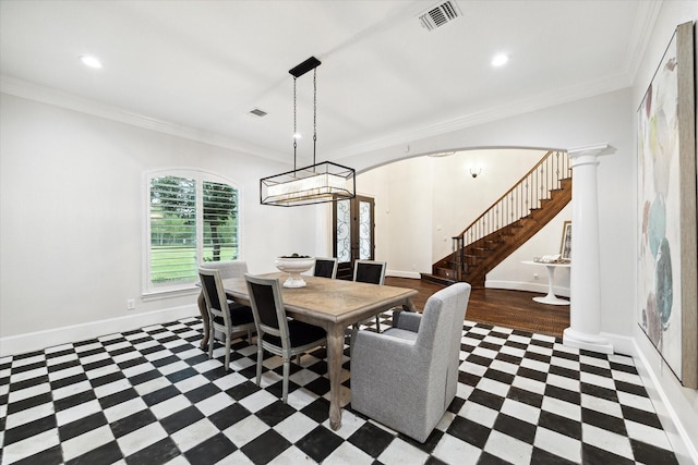 dining area featuring crown molding and decorative columns