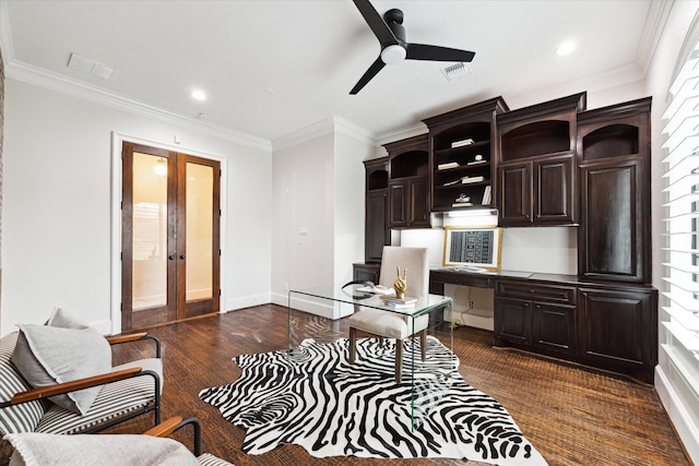 office space featuring built in desk, ceiling fan, dark hardwood / wood-style flooring, and ornamental molding