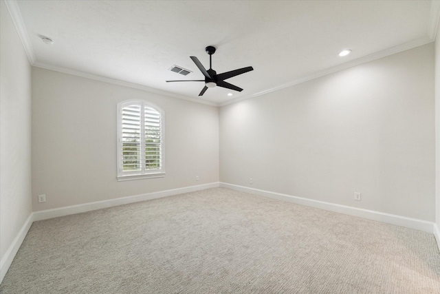 carpeted spare room featuring ceiling fan and crown molding