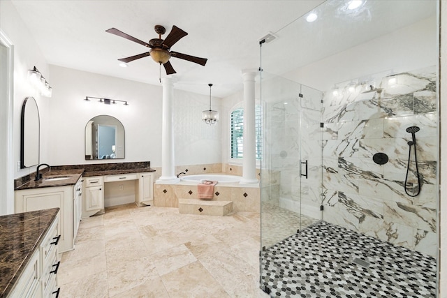 bathroom featuring ceiling fan with notable chandelier, vanity, ornate columns, and shower with separate bathtub