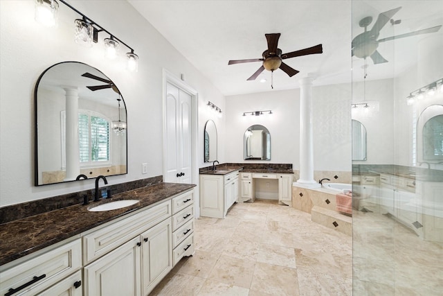 bathroom featuring ceiling fan, tiled tub, vanity, and decorative columns