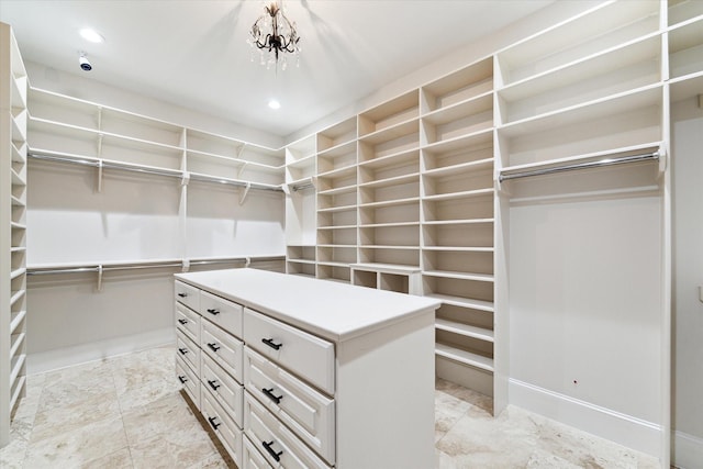 spacious closet with an inviting chandelier