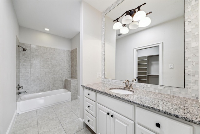 bathroom featuring tiled shower / bath combo, tile patterned floors, and vanity