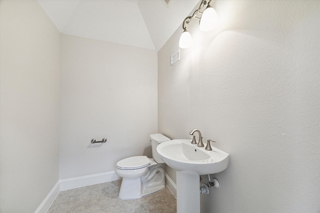 bathroom with toilet and vaulted ceiling