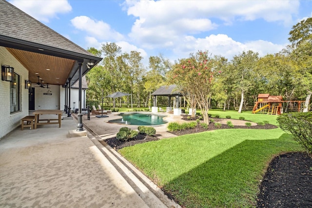 view of yard featuring ceiling fan, a gazebo, a patio, and a playground