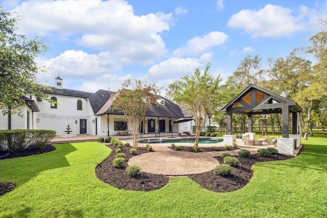 back of house featuring a patio area, a gazebo, and a lawn