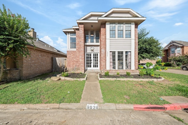 view of front property with french doors and a front yard