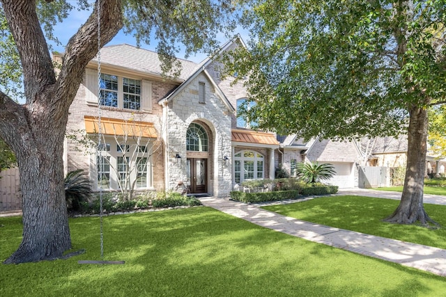 view of front of home featuring a garage and a front yard