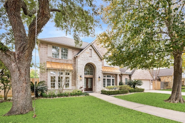 view of front of property with a garage and a front lawn