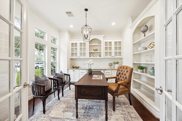 sunroom featuring french doors and an inviting chandelier