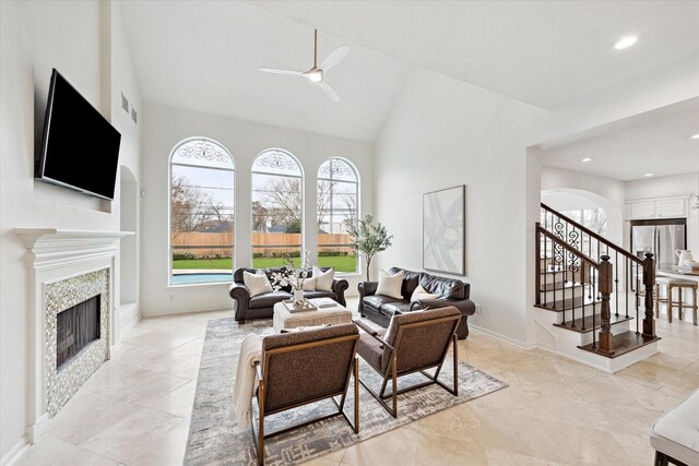 living room featuring vaulted ceiling and ceiling fan