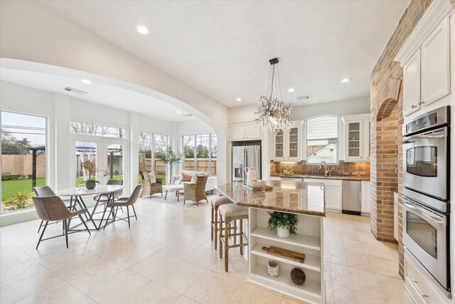 kitchen with stainless steel appliances, white cabinets, and a kitchen island