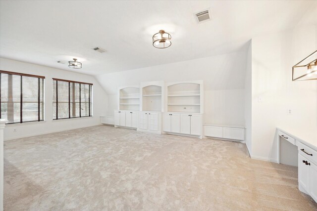 interior space with built in shelves and light carpet