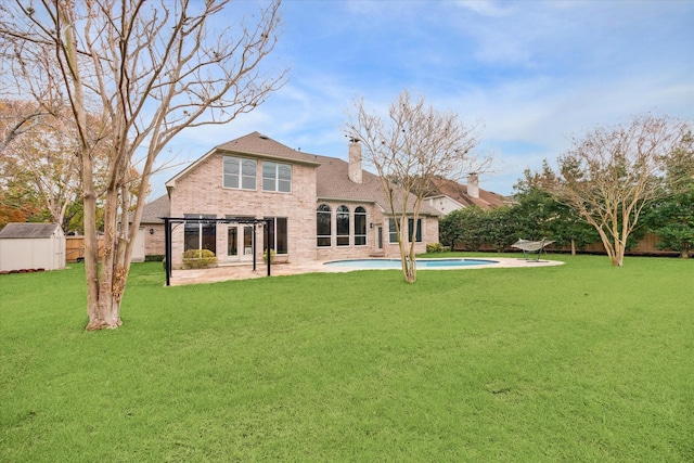 back of property with a lawn, a pergola, a shed, a fenced in pool, and a patio area