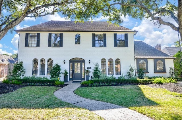 view of front facade featuring a front lawn and french doors