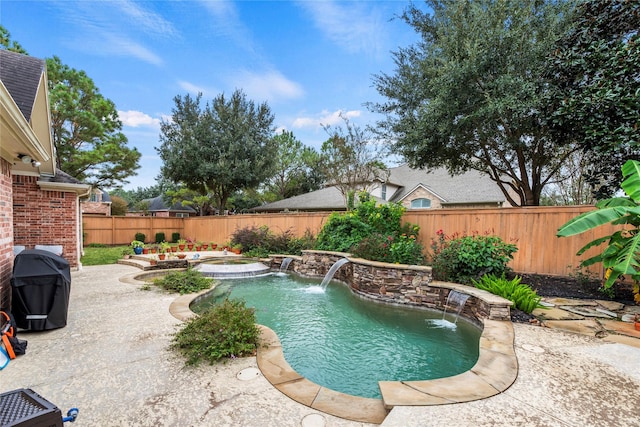 view of swimming pool with a patio area, area for grilling, an in ground hot tub, and pool water feature