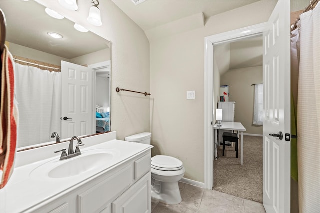 bathroom with tile patterned flooring, toilet, vanity, and vaulted ceiling