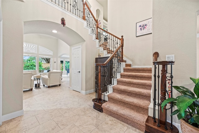 stairway featuring a high ceiling