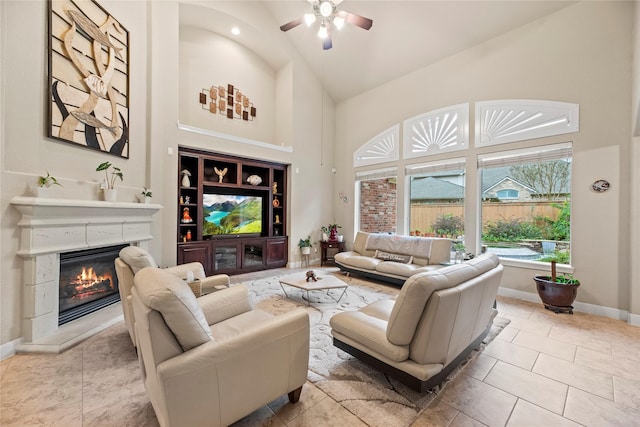 tiled living room with high vaulted ceiling, built in shelves, and ceiling fan