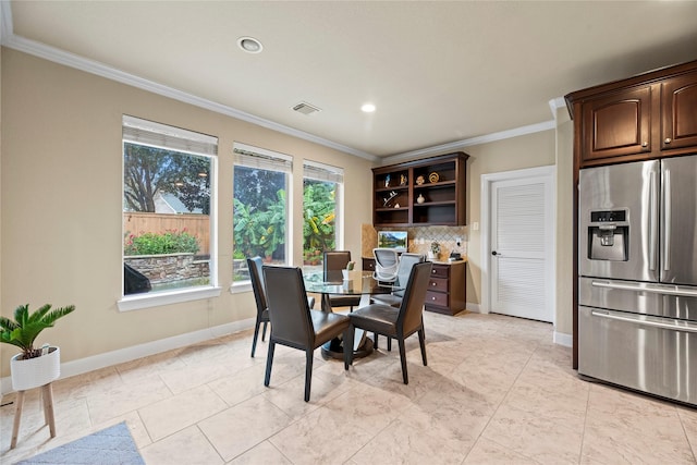 tiled dining room featuring crown molding