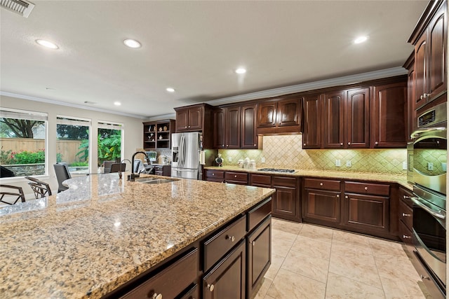 kitchen with stainless steel appliances, light stone countertops, ornamental molding, a breakfast bar, and sink