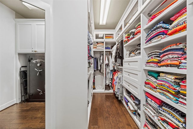 spacious closet with dark hardwood / wood-style flooring