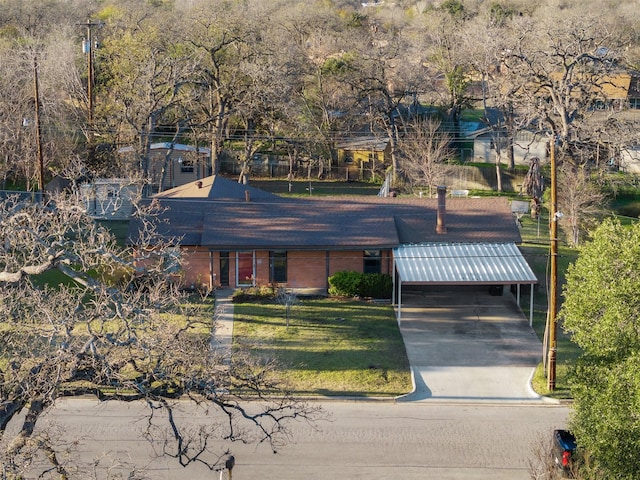 exterior space with a front lawn and a carport