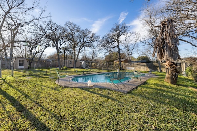 view of pool with a shed and a yard