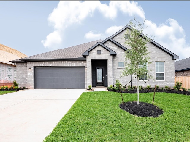 view of front facade with a garage and a front yard