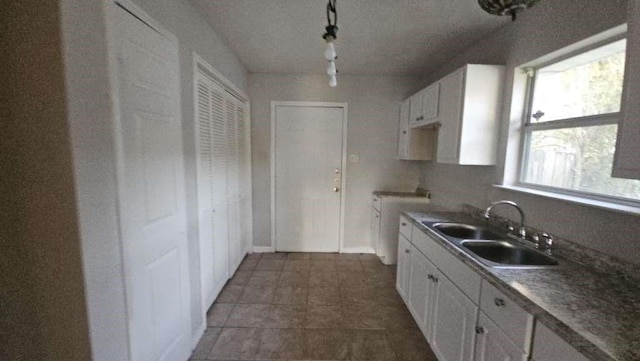 kitchen featuring white cabinets and sink