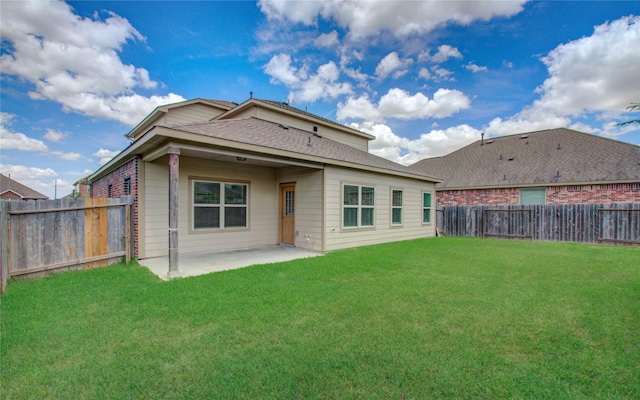 back of property featuring a patio area and a yard