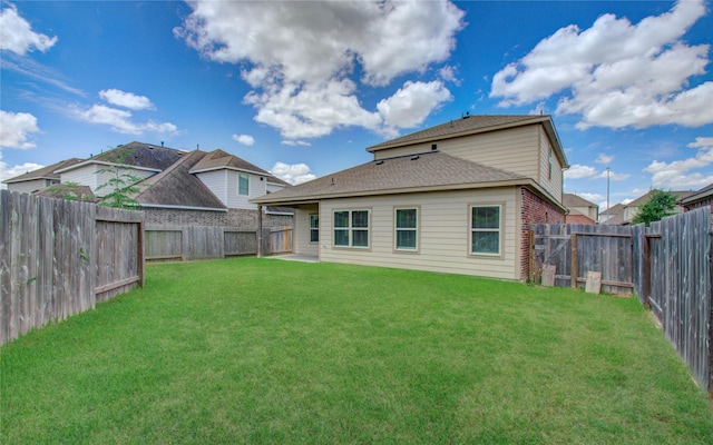 back of property featuring a lawn