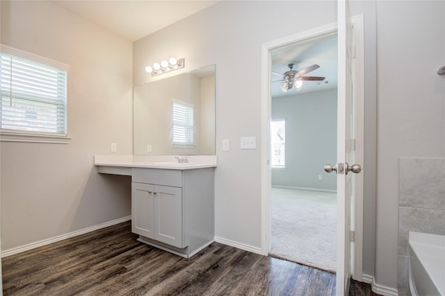 bathroom featuring ceiling fan, a wealth of natural light, wood-type flooring, and vanity