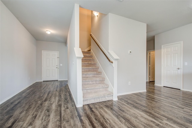 staircase with hardwood / wood-style flooring