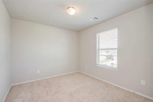 unfurnished room with light colored carpet