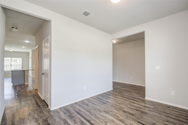 empty room with dark wood-type flooring