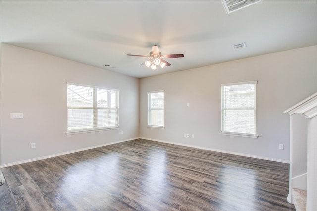 empty room with ceiling fan and dark hardwood / wood-style flooring