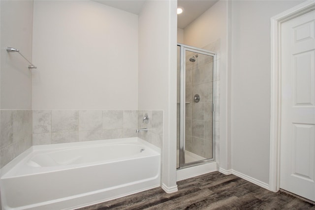 bathroom featuring separate shower and tub and hardwood / wood-style floors