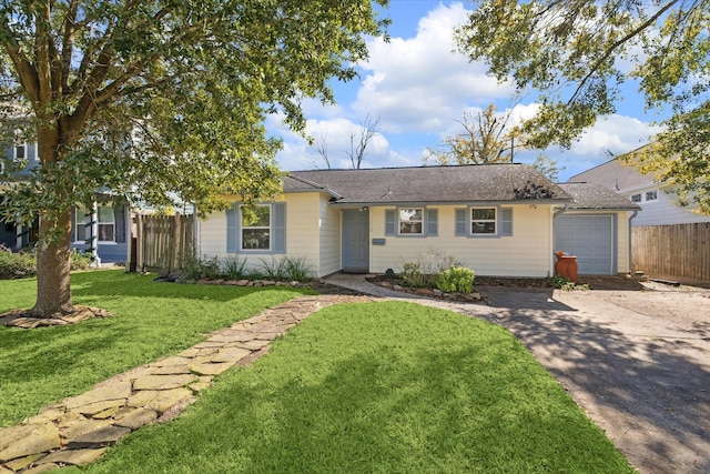 ranch-style home featuring a garage and a front lawn