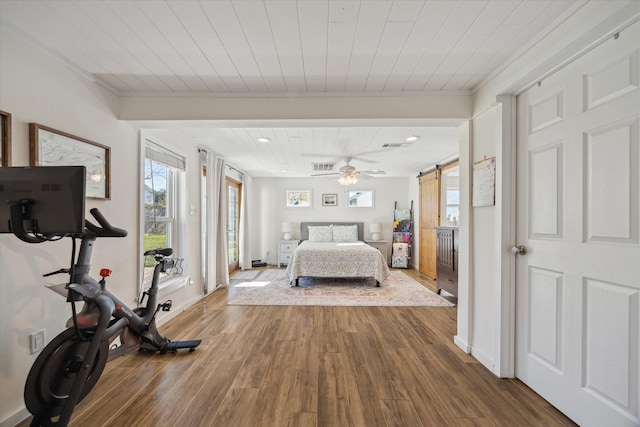 bedroom with wooden ceiling, crown molding, a barn door, and wood-type flooring