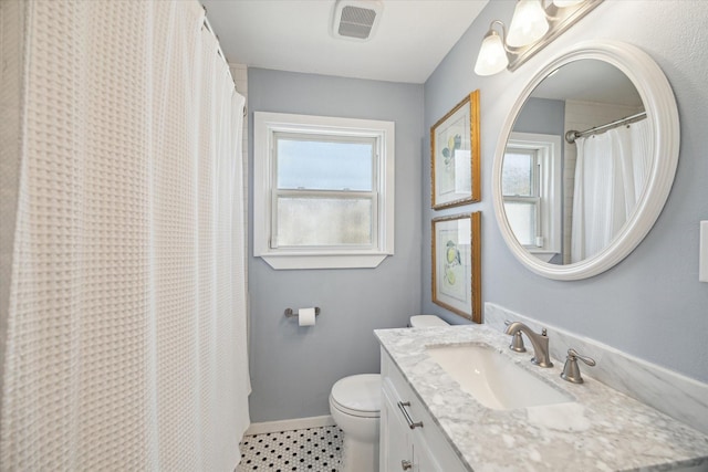 bathroom with toilet, vanity, and a shower with curtain