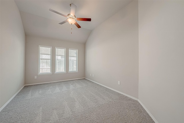 carpeted empty room featuring ceiling fan and lofted ceiling