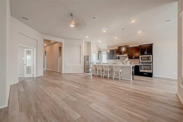 unfurnished living room with ceiling fan and light hardwood / wood-style floors