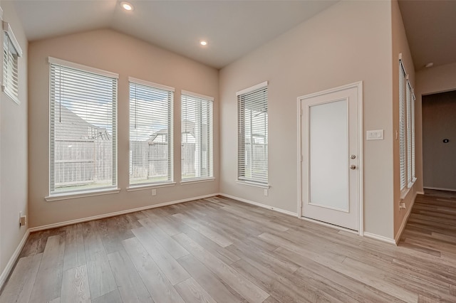 interior space with lofted ceiling and light hardwood / wood-style flooring